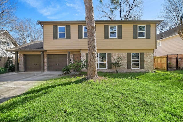 colonial-style house with brick siding, an attached garage, fence, a front yard, and driveway