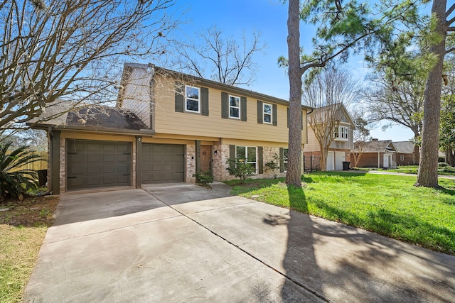 colonial house with a front lawn, an attached garage, and driveway