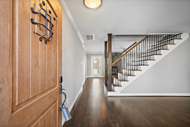 entrance foyer featuring visible vents, crown molding, baseboards, stairway, and dark wood-style flooring