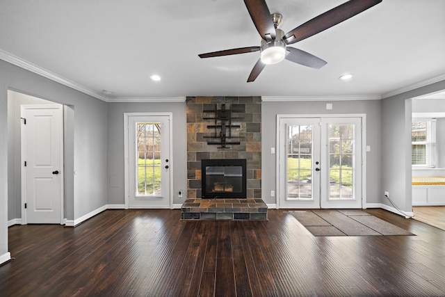 unfurnished living room featuring a healthy amount of sunlight, wood-type flooring, and ornamental molding