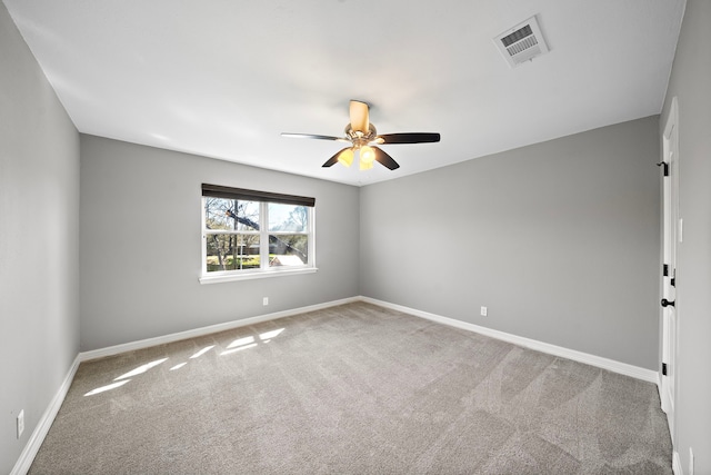 unfurnished room featuring carpet flooring, a ceiling fan, visible vents, and baseboards