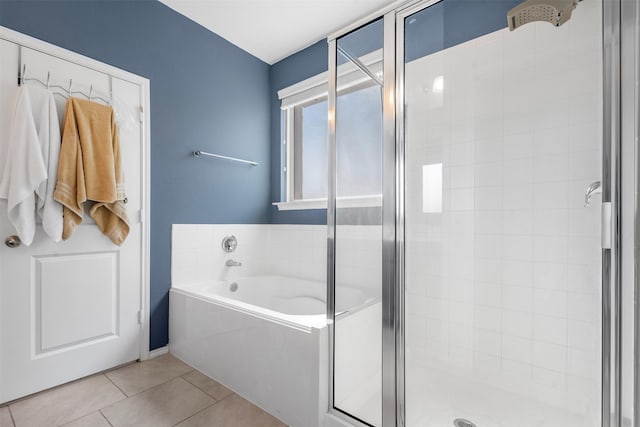 full bath with tile patterned floors, a bath, and a stall shower