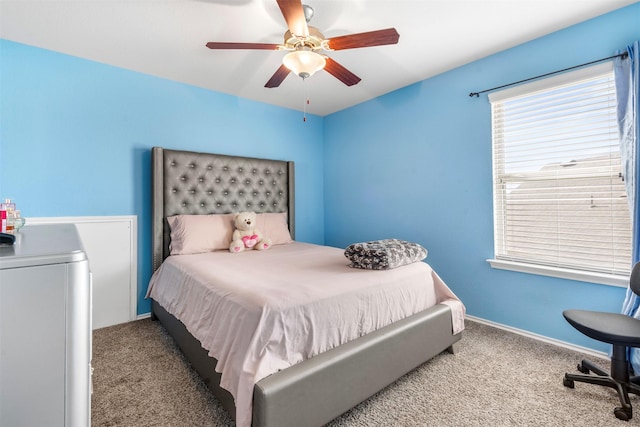 carpeted bedroom featuring baseboards and ceiling fan