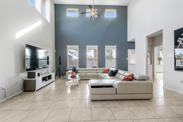 living room featuring light tile patterned floors, a healthy amount of sunlight, and a ceiling fan