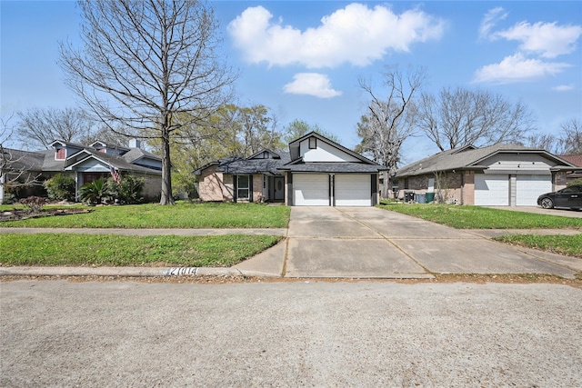 view of front of house featuring a front yard, a garage, and driveway