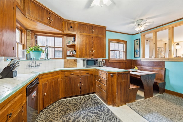 kitchen featuring tile countertops, stainless steel appliances, brown cabinets, and ceiling fan