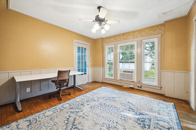 home office with ceiling fan, cooling unit, wood finished floors, and wainscoting