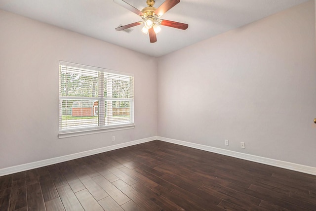 spare room with ceiling fan, baseboards, and dark wood-style floors