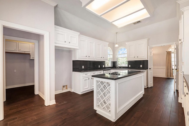 kitchen featuring visible vents, dark countertops, white cabinets, and dark wood finished floors