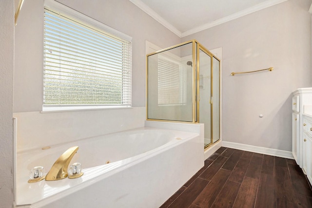 bathroom with wood finished floors, baseboards, a shower stall, crown molding, and a garden tub