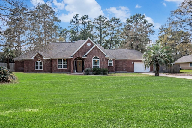 single story home with brick siding, a garage, driveway, and a front lawn