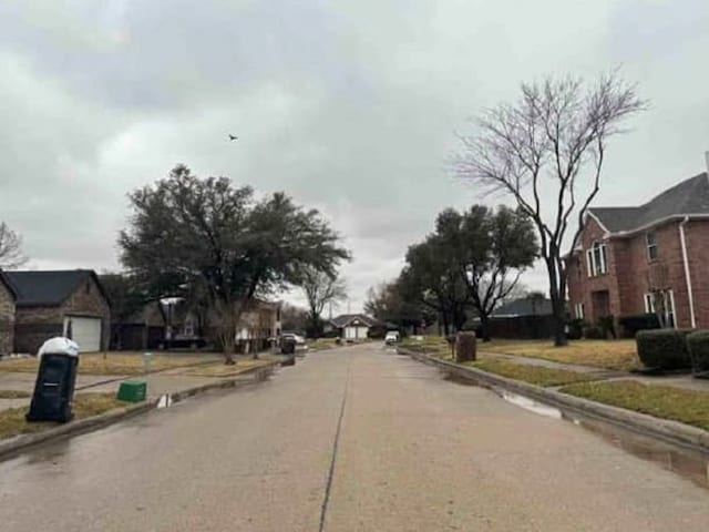 view of road featuring sidewalks and a residential view