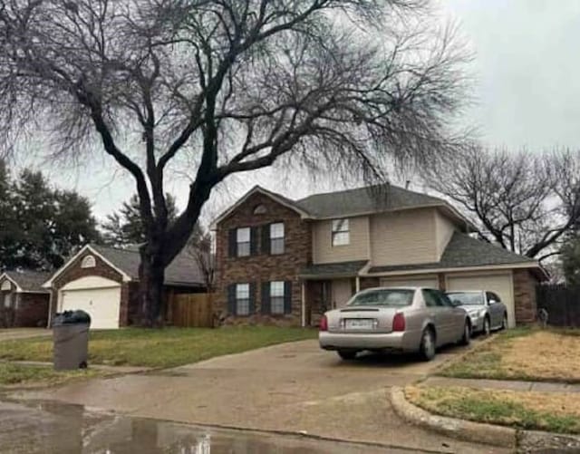 traditional home featuring a garage and concrete driveway