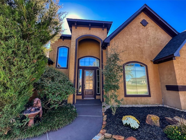 doorway to property with stucco siding