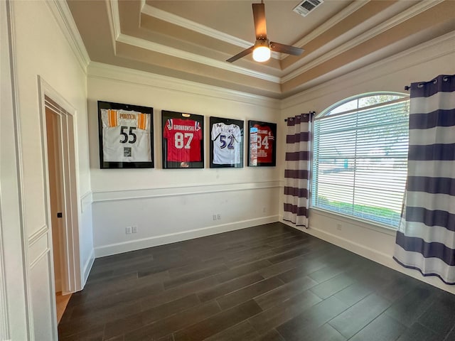 unfurnished room featuring visible vents, a ceiling fan, dark wood finished floors, crown molding, and a raised ceiling