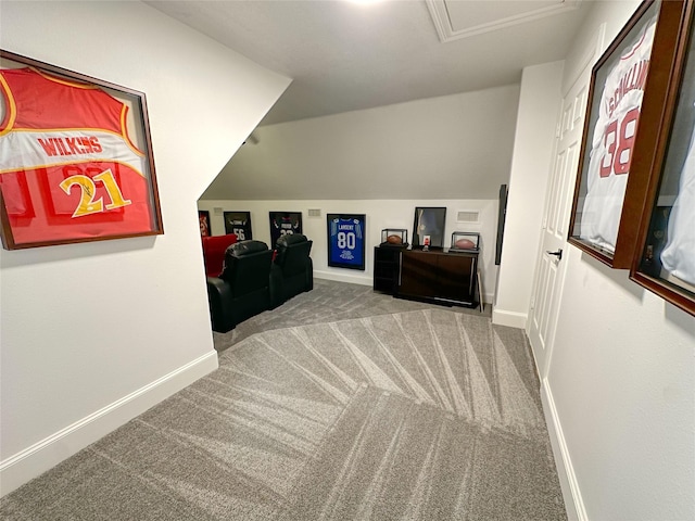 bonus room with baseboards, carpet floors, lofted ceiling, and attic access