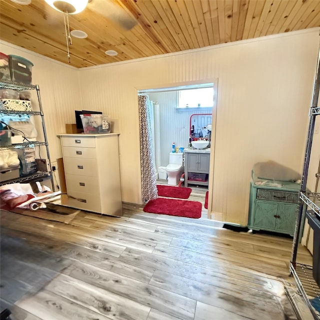 interior space featuring wooden ceiling, ornamental molding, and light wood finished floors