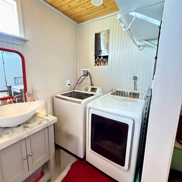 washroom with a sink, separate washer and dryer, wooden ceiling, and laundry area