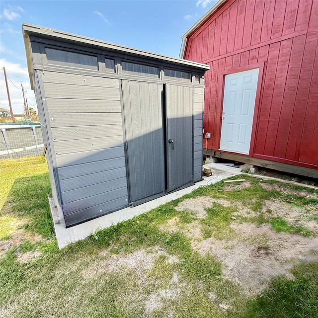 view of shed with fence