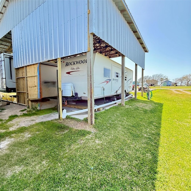 exterior space featuring a yard and an outbuilding