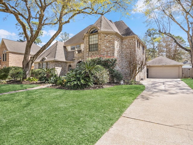 view of front of house featuring a front yard, a garage, brick siding, and concrete driveway