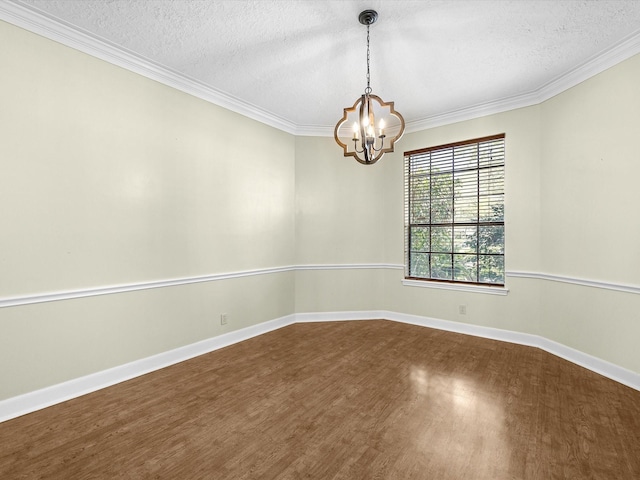 unfurnished room featuring baseboards, ornamental molding, an inviting chandelier, dark wood-style floors, and a textured ceiling