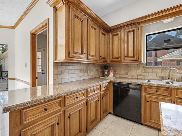 kitchen with brown cabinets, a sink, dishwasher, tasteful backsplash, and a wealth of natural light