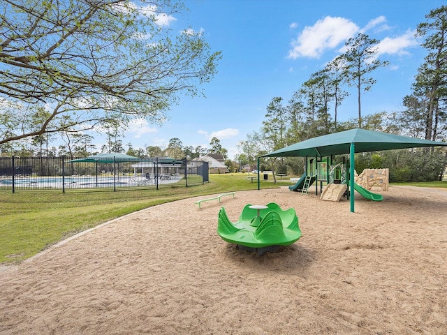 community play area featuring a yard, fence, and a fenced in pool