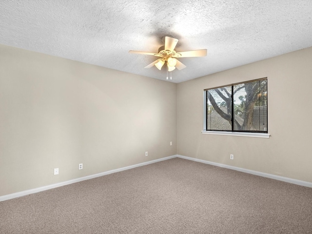 carpeted empty room with baseboards, a textured ceiling, and a ceiling fan