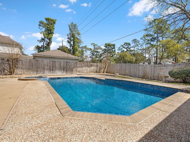 view of swimming pool with a patio area, a fenced backyard, and a pool with connected hot tub