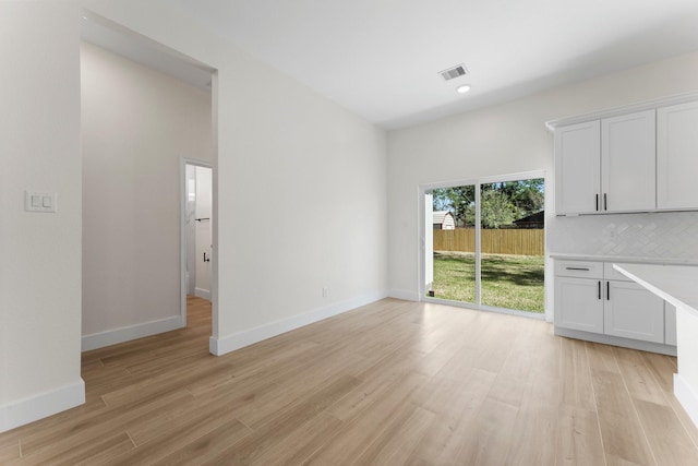 unfurnished living room featuring visible vents, recessed lighting, baseboards, and light wood-style floors