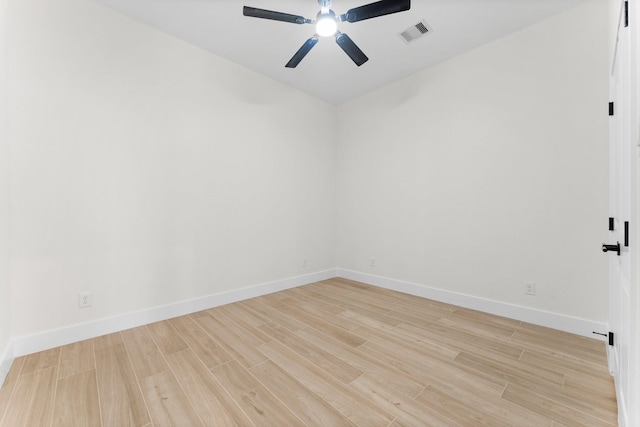 unfurnished room featuring baseboards, wood finished floors, visible vents, and ceiling fan