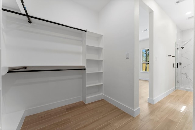 walk in closet featuring visible vents and light wood-type flooring