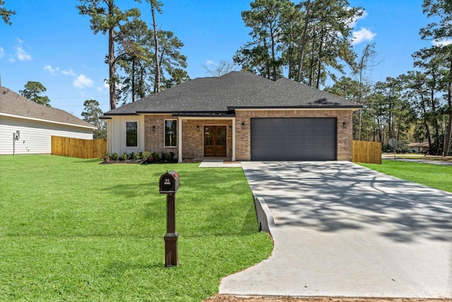 view of front facade featuring brick siding, fence, a front yard, a garage, and driveway