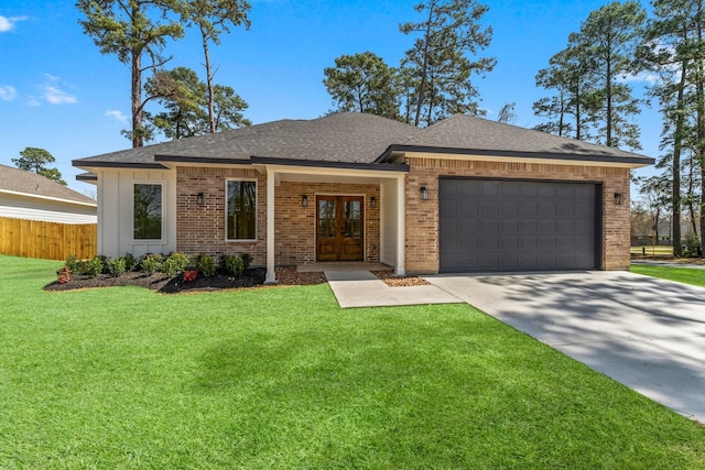 view of front of property featuring a front yard, a garage, fence, and brick siding