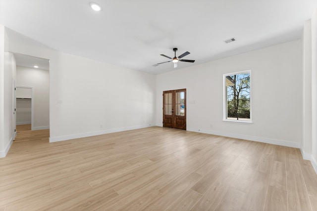 spare room featuring a ceiling fan, baseboards, visible vents, recessed lighting, and light wood-type flooring