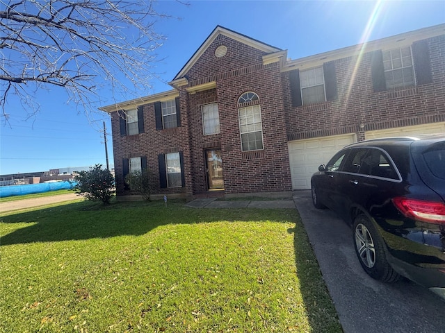 view of front of home with brick siding, a garage, a front yard, and driveway