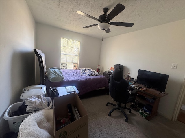 carpeted bedroom with a textured ceiling and ceiling fan