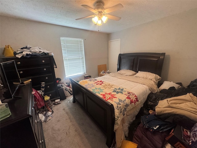 bedroom with a textured ceiling, ceiling fan, and light carpet