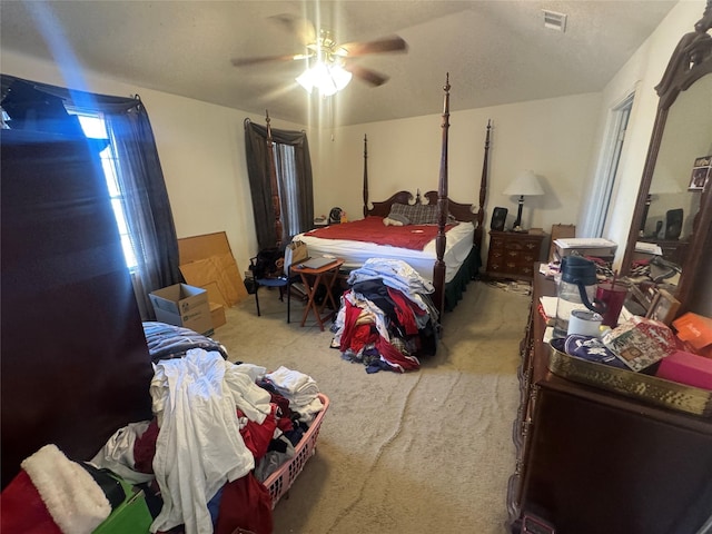 bedroom featuring visible vents, ceiling fan, and carpet