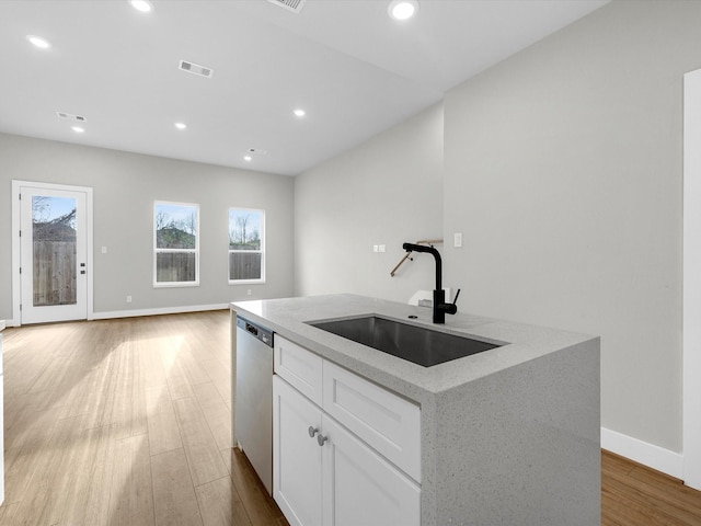 kitchen with an island with sink, a sink, wood finished floors, recessed lighting, and dishwasher