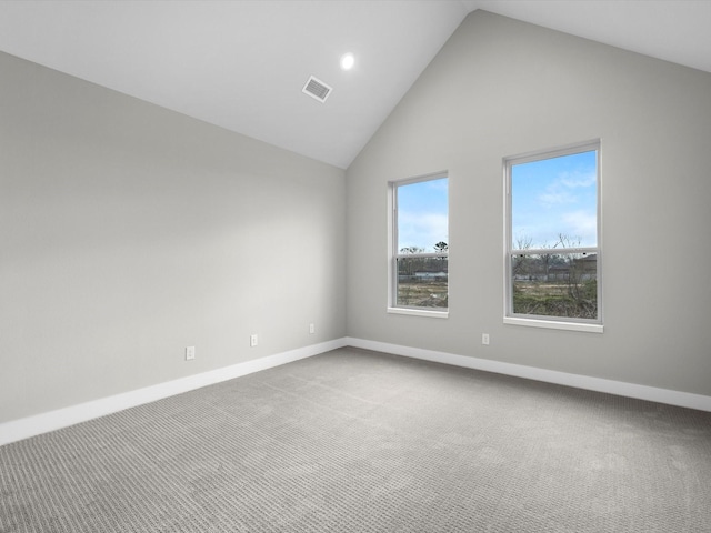 spare room featuring visible vents, high vaulted ceiling, baseboards, and carpet floors