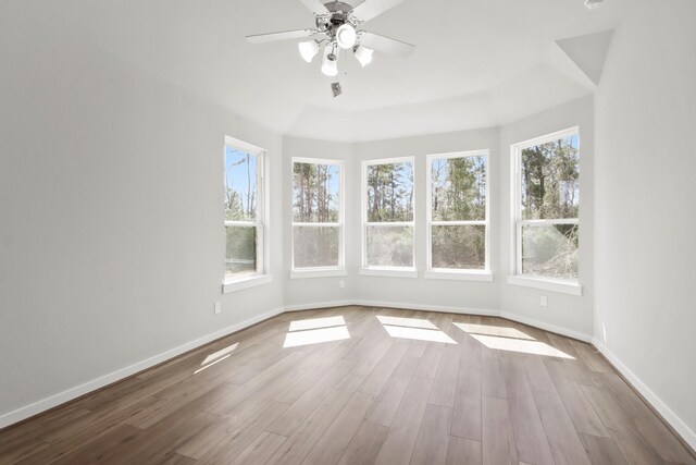 unfurnished sunroom with ceiling fan