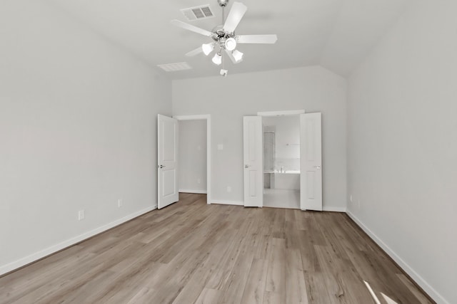 unfurnished bedroom with visible vents, baseboards, vaulted ceiling, and light wood finished floors