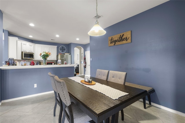 dining area with visible vents, recessed lighting, arched walkways, light tile patterned flooring, and baseboards