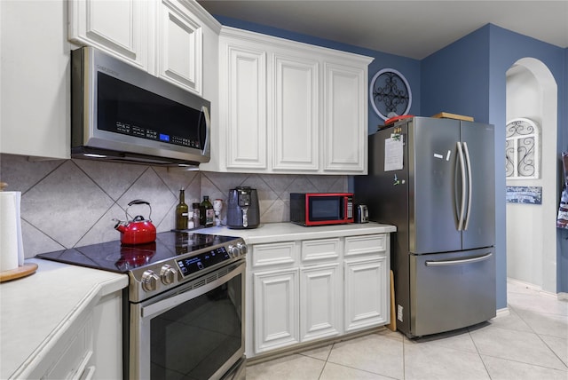 kitchen with white cabinetry, light countertops, tasteful backsplash, and stainless steel appliances