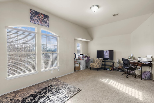 office space featuring visible vents, carpet flooring, and vaulted ceiling