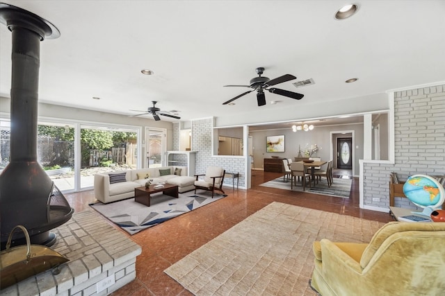 living room featuring visible vents, recessed lighting, a wood stove, and ceiling fan