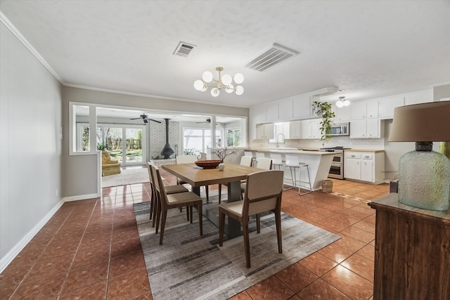 dining space featuring tile patterned floors, ceiling fan with notable chandelier, visible vents, and baseboards