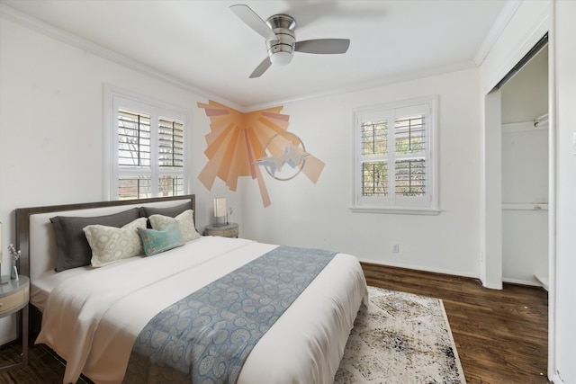 bedroom with a ceiling fan, multiple windows, wood finished floors, and ornamental molding